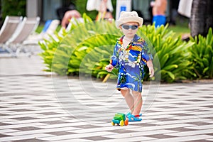 Adorable toddler boy in summer holiday resort in Mauritius, casually dressed