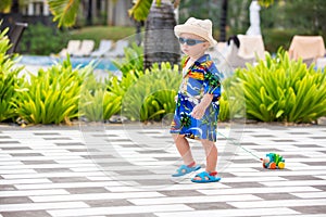 Adorable toddler boy in summer holiday resort in Mauritius, casually dressed