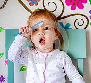 Adorable Toddler Girl Brushes Her Teeth in Pajamas. Health Care concept.