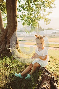 Adorable toddler girl eating ice cream outdoors