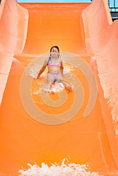 Adorable toddler girl enjoying her summer vacation at aquapark