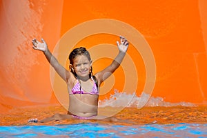 Adorable toddler girl enjoying her summer vacation at aquapark