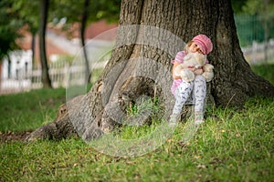 Adorable toddler girl hugging her favourite teddy bear