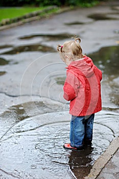 Adorable toddler girl at rainy day