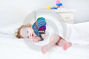 Adorable toddler girl waking up in the morning