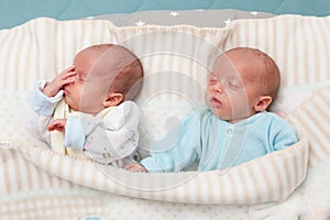 Adorable twin babies sleeping in the bed. Closeup portrait, caucasian child