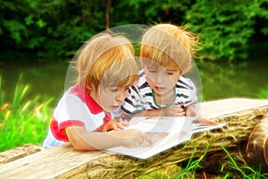 Adorable Twin Brothers Reading A Book Near The Lake At Summer