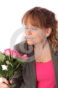 Adorable woman holding pink roses