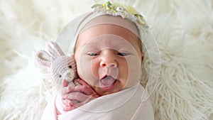 Adorable Yawning Newborn Baby Hugging A Toy