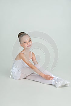 Adorable young ballerina poses on camera