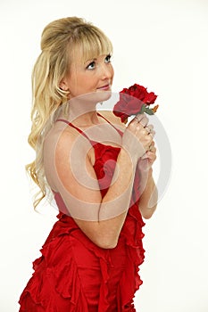 Adorable young blonde woman with red rose