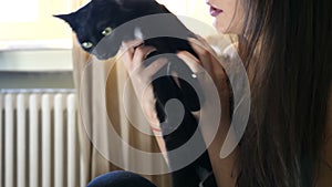 Adorable young couple in the living room relaxing and playing with their cats