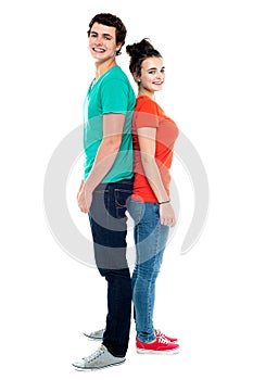 Adorable young couple posing back to back
