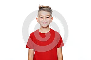 Adorable young teenage boy waist up studio portrait isolated over white background. Handsome boy looking at camera with smile.