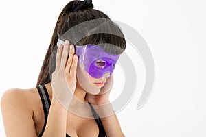 Adorable young woman wearing gel eye mask