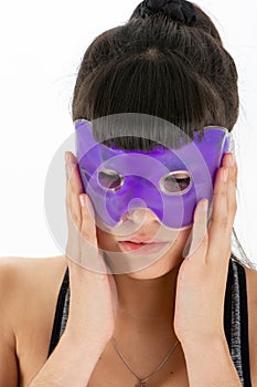 Adorable young woman wearing gel eye mask