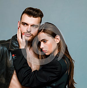 She adores male brutal beard. Girlfriend passionate red lips and man leather jacket. Passionate hug. Couple passionate photo