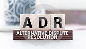 ADR Adverse drug reaction. text on wood cubes on white background