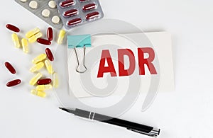 ADR text written in a card with pills. Medical concept