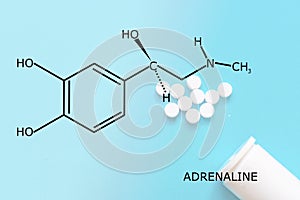 Adrenaline molecule structure with some pills dropped at a blue background
