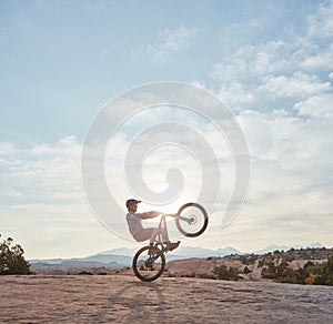 Adrenaline is my drug of choice. a young man out mountain biking during the day.