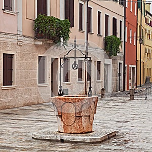 Adria, Rovigo, Veneto, Italy: the ancient water well in the old photo