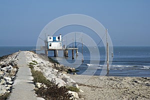 Adriatic, Italy. Stilt house by the sea and fishing nets