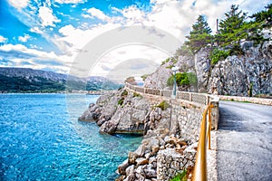 Adriatic sea coastline with dramatic sky and sunlight. Rocky coastline with ocean waves hitting rocks. Travel concept