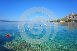 Adriatic seacoast, beach with clear water of the sea and blue sky, Omis, Croatia, Dalmatia. Outdoor travel background