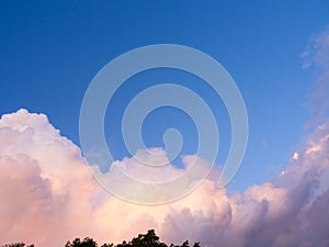Adstract colour of fluffy cumulus pinky clouds in clear blue sky in bright suny day, in summer daytime sky. nature landscape