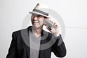 Adult Asian man with tin can phone