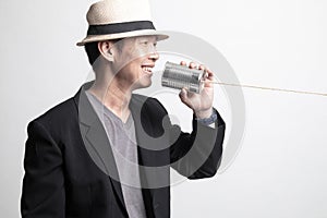 Adult Asian man  with tin can phone