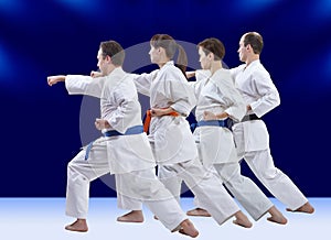 Adult athletes in karategi are training punch arm photo