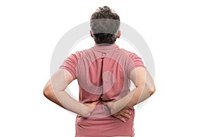 Adult with back muscular pain touching lumbar region copyspace photo