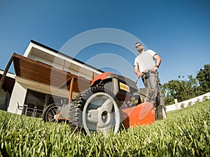 Adult bearded male with lawnmower