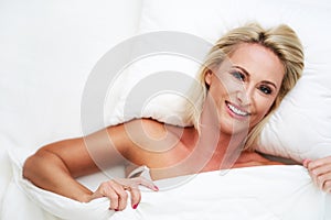 Adult beautiful woman waking up fully rested.