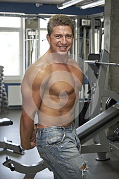 Adult bodybuilder posing in gym
