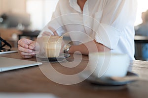 Adult businessman drinking coffee in cafe