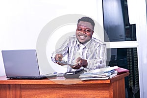 Adult businessman holding digital tablet in office smiling