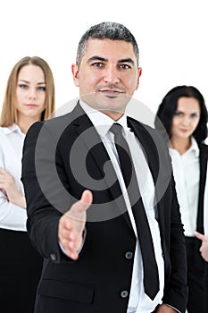 Adult businessman standing in front of his colleagues