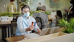 An adult businessman is talking with someone on the phone during working