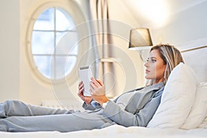 Businesswoman using tablet computer in hotel room