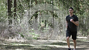 Adult caucasian athlete is jogging on the track at the park preparing to workout