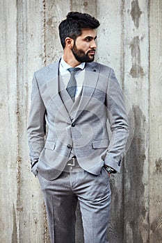 Adult caucasian brunet businessman wear grey suit pose