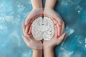 Adult and child hands holding encephalography brain paper cutout, autism, Stroke, Epilepsy and Alzheimer awareness