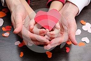 Adult and child hands holding heart shape, health care, donate and family insurance concept