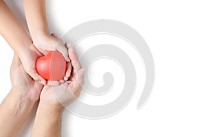 Adult and child hands holding red heart isolated