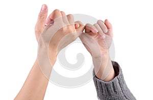 An adult and a child are making a pinky promise / pinkie swear, isolated with white background