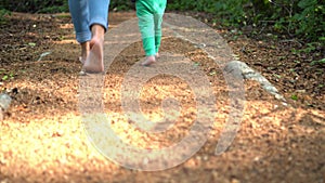 Adult and children feet barefoot walk on sensory path sawdust surface