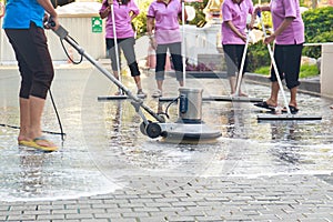 Adult cleaner maid woman with mop and uniform cleaning corridor